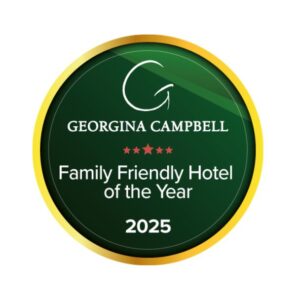 A circular badge reads "Georgina Campbell Family Friendly Hotel of the Year 2025" with five red stars and a gold border.