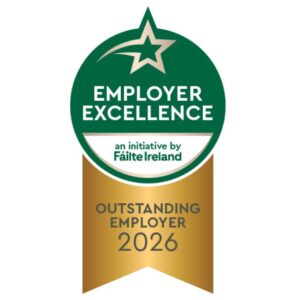 A green and gold badge reading "Employer Excellence, an initiative by Fáilte Ireland, Outstanding Employer 2026.